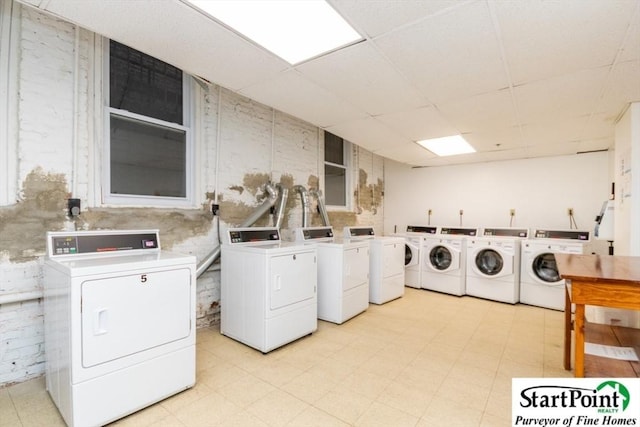 common laundry area featuring light floors and washing machine and clothes dryer