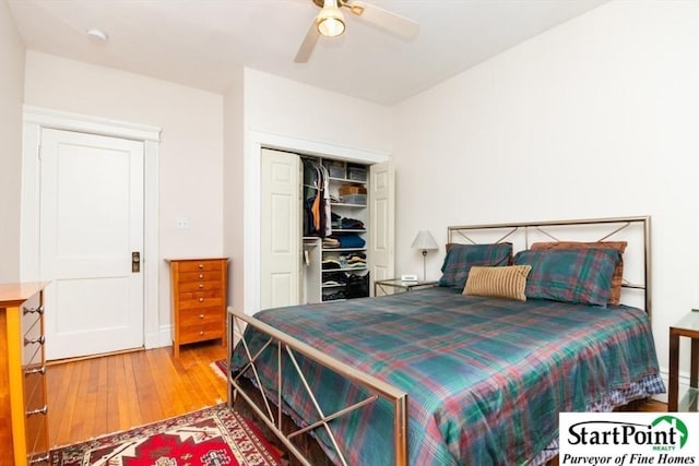 bedroom with a closet, wood finished floors, and a ceiling fan