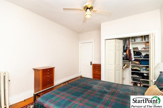 bedroom featuring a closet, baseboards, radiator heating unit, and wood finished floors