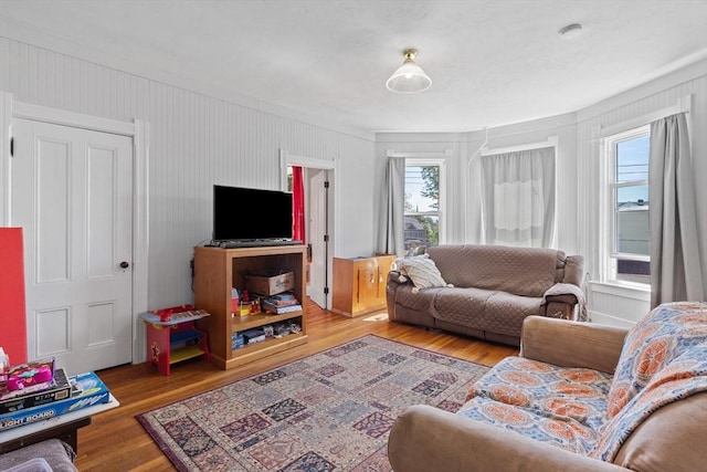 living room with plenty of natural light and wood finished floors