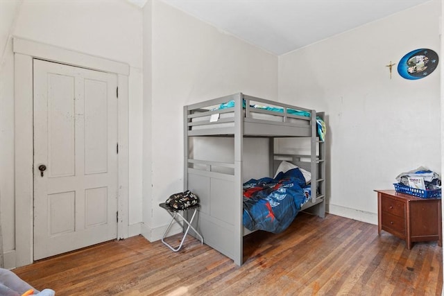 bedroom with wood finished floors and baseboards