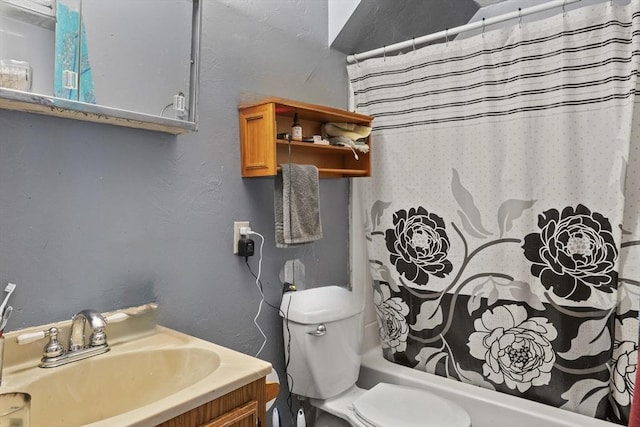 bathroom featuring toilet, vanity, a textured wall, and shower / tub combo with curtain