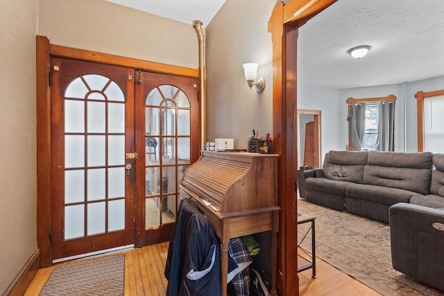 washroom featuring wood-type flooring and french doors