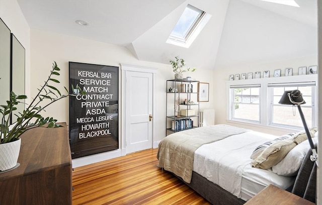 49 Prince St Unit 2, Boston, MA 02130 - bedroom featuring a skylight, radiator heating unit, wood finished floors, and high vaulted ceiling