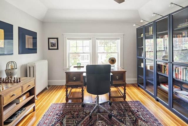 49 Prince St Unit 2, Boston, MA 02130 - office area with radiator heating unit, light wood-style floors, vaulted ceiling, baseboards, and ceiling fan