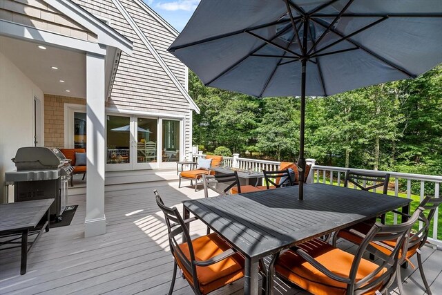 wooden terrace with a grill