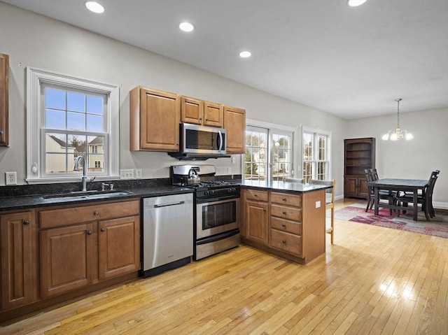 36 Knowlton Cir Unit 36, Upton, MA 01568 - kitchen featuring appliances with stainless steel finishes, a peninsula, light wood-style flooring, brown cabinetry, and recessed lighting