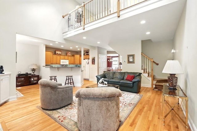 11 High Pine Cir Unit 11, Wilbraham, MA 01095 - living area with stairway, light wood-style floors, recessed lighting, a towering ceiling, and baseboards