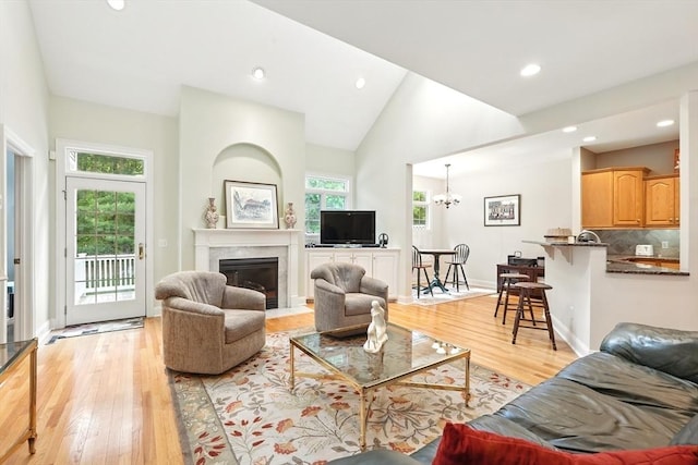 11 High Pine Cir Unit 11, Wilbraham, MA 01095 - living room featuring light wood finished floors, recessed lighting, a chandelier, a fireplace with flush hearth, and baseboards