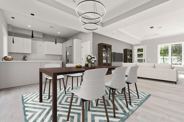 dining room with a chandelier and light wood-style floors