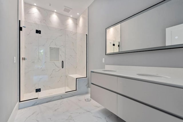 bathroom with marble finish floor, double vanity, a marble finish shower, and recessed lighting