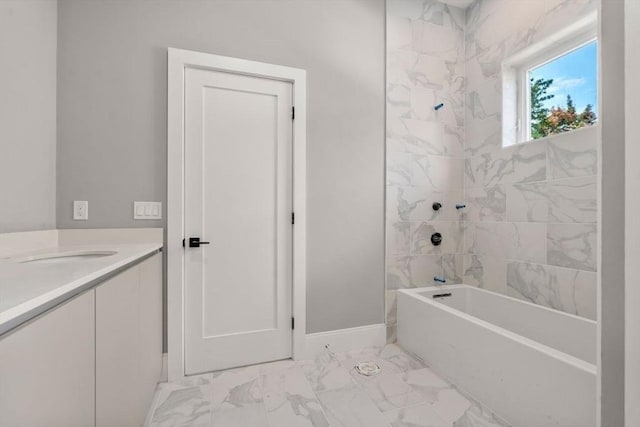 full bath with marble finish floor, vanity, baseboards, and bathing tub / shower combination