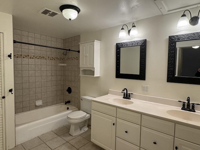 full bathroom featuring toilet, vanity, tile patterned floors, and tiled shower / bath