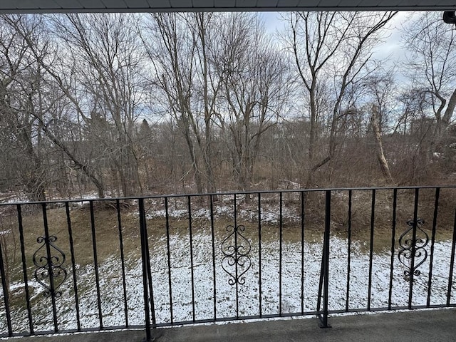 view of snow covered back of property