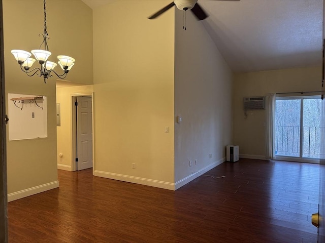 unfurnished living room featuring ceiling fan with notable chandelier, high vaulted ceiling, a wall unit AC, and dark wood-type flooring