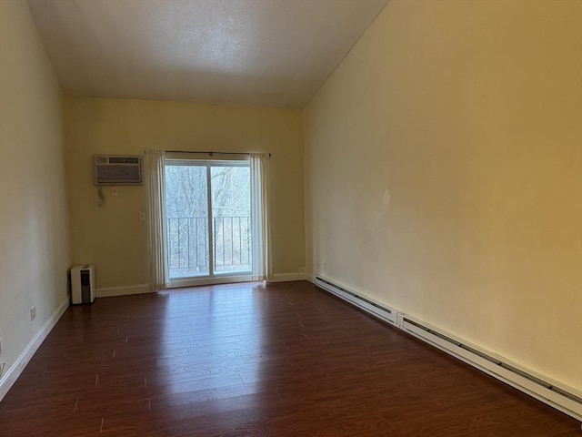 unfurnished room with a wall mounted AC, dark hardwood / wood-style flooring, and a baseboard heating unit