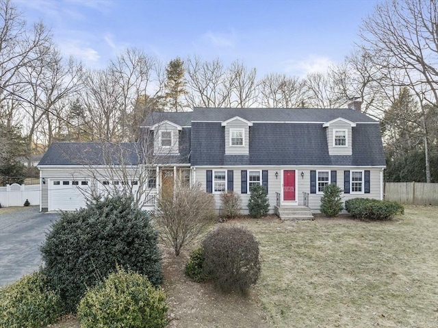 cape cod home with a garage