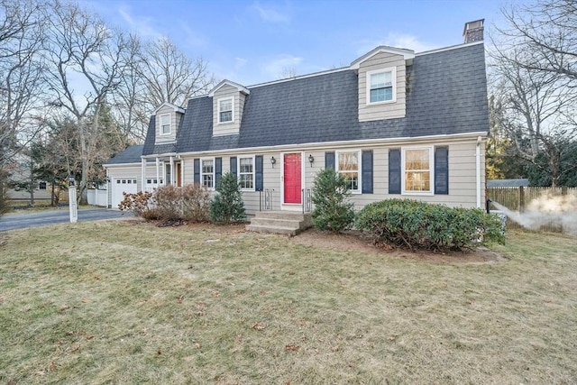 cape cod-style house featuring a front yard