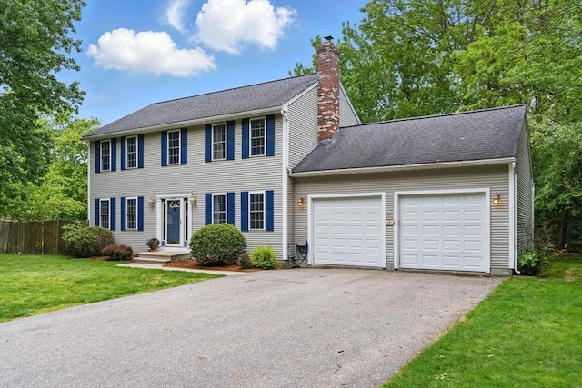 507 Towne St, North Attleboro, MA 02760 - colonial inspired home with a chimney, asphalt driveway, and an attached garage