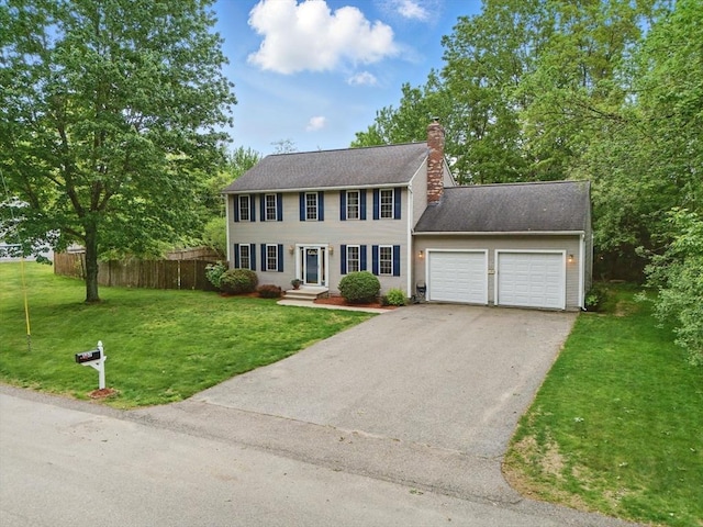 507 Towne St, North Attleboro, MA 02760 - colonial-style house featuring a garage, asphalt driveway, and a chimney