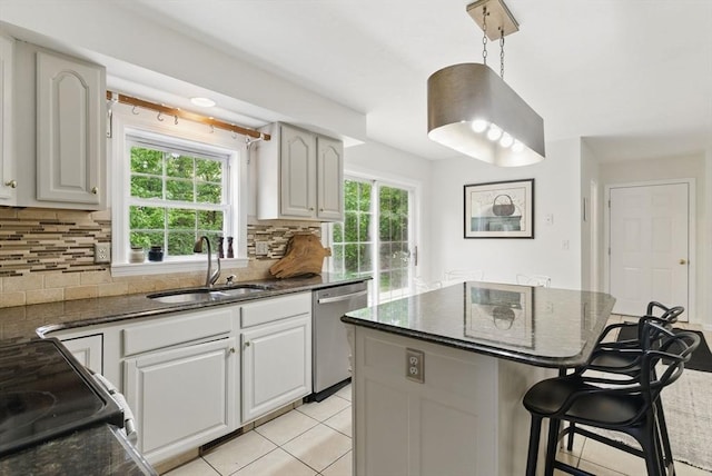 507 Towne St, North Attleboro, MA 02760 - kitchen with a sink, dishwasher, a kitchen bar, decorative backsplash, and dark stone countertops