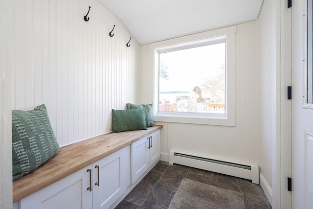 mudroom with a baseboard heating unit, stone finish flooring, and vaulted ceiling