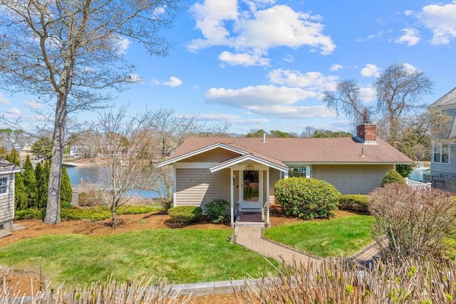 160 Waterway, Mashpee, MA 02649 - view of front of home with a front lawn, a chimney, and a water view
