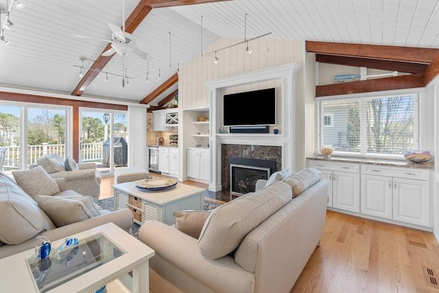 160 Waterway, Mashpee, MA 02649 - living room featuring light wood-type flooring, a high end fireplace, wood ceiling, rail lighting, and beverage cooler