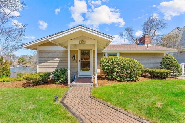 160 Waterway, Mashpee, MA 02649 - view of front of property featuring a front lawn, a chimney, and roof with shingles