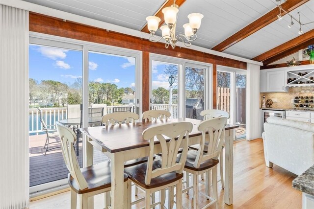 160 Waterway, Mashpee, MA 02649 - dining area with a chandelier, light wood-type flooring, wood ceiling, beverage cooler, and a bar