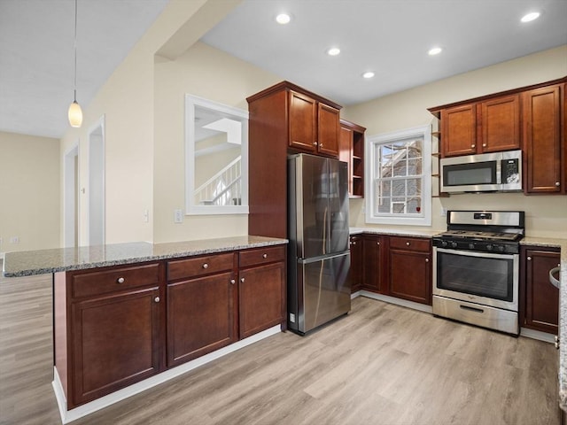 kitchen with stainless steel appliances, light wood-style floors, light stone counters, and open shelves