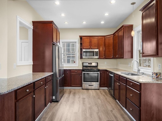 kitchen with open shelves, recessed lighting, appliances with stainless steel finishes, a sink, and light wood-type flooring