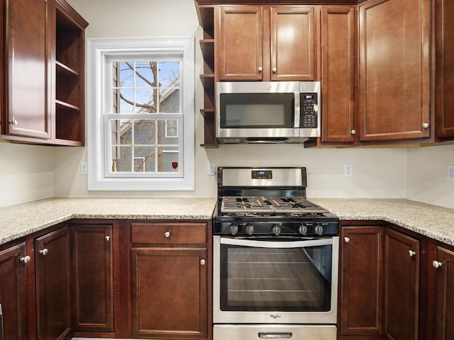 kitchen with open shelves and appliances with stainless steel finishes