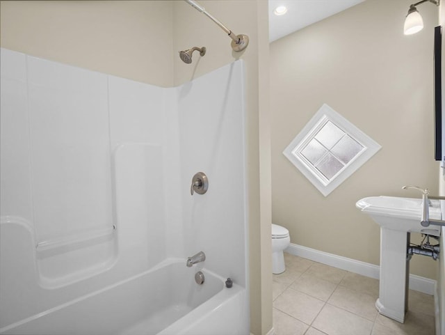 bathroom featuring baseboards, shower / washtub combination, toilet, and tile patterned floors