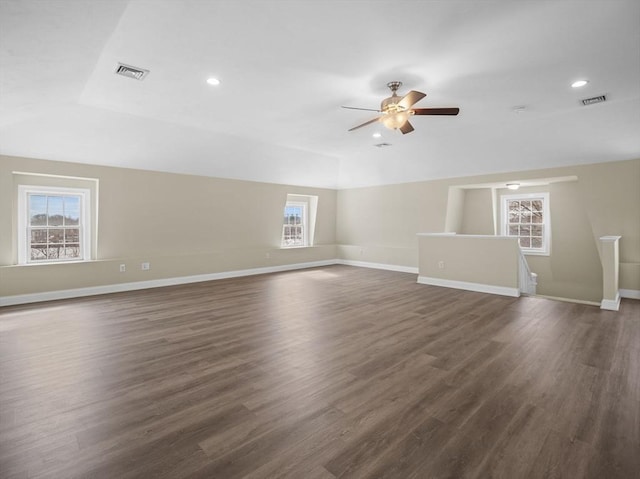 unfurnished room featuring visible vents, dark wood finished floors, and baseboards