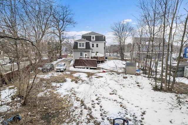 snow covered house with a deck