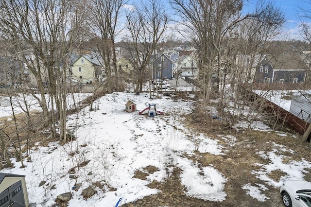 yard covered in snow featuring a residential view