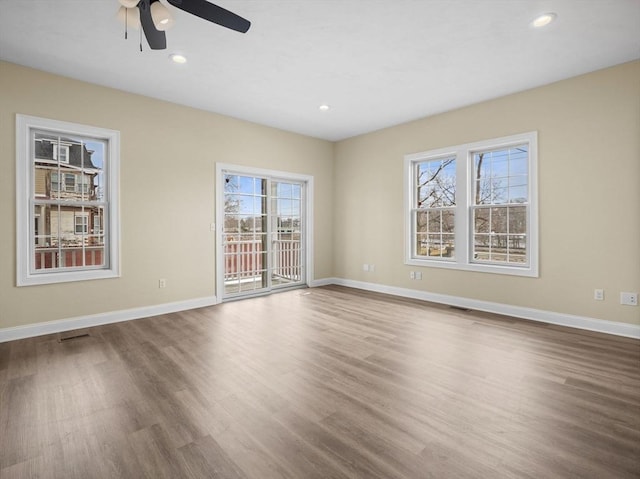 spare room featuring baseboards, visible vents, wood finished floors, and recessed lighting