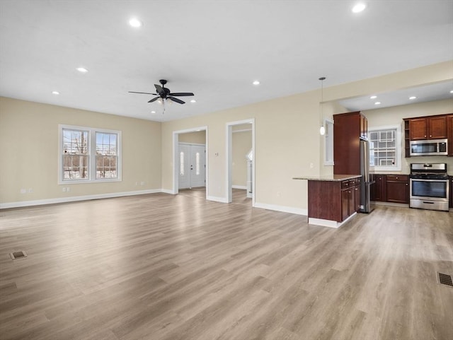 unfurnished living room with recessed lighting, baseboards, visible vents, and light wood finished floors