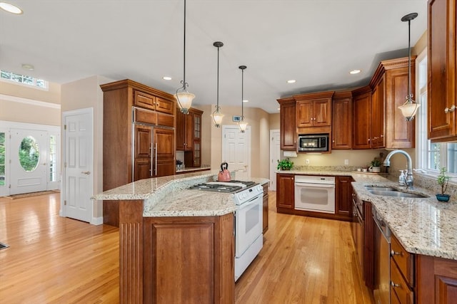 20 Peakham Rd, Sudbury, MA 01776 - kitchen featuring stainless steel appliances, brown cabinetry, a sink, and light wood-style floors