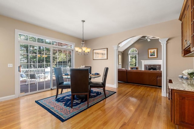 20 Peakham Rd, Sudbury, MA 01776 - dining room with decorative columns, arched walkways, a fireplace, baseboards, and light wood finished floors