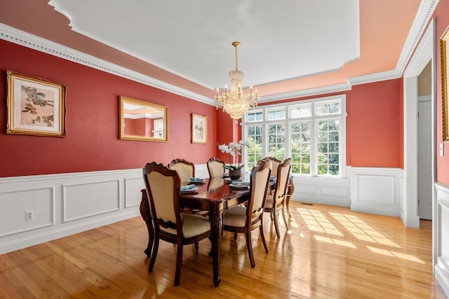 20 Peakham Rd, Sudbury, MA 01776 - dining space with an inviting chandelier, ornamental molding, light wood-style floors, and a decorative wall