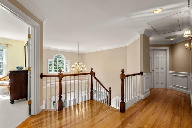 20 Peakham Rd, Sudbury, MA 01776 - corridor featuring crown molding, an inviting chandelier, attic access, an upstairs landing, and wood finished floors