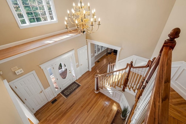 20 Peakham Rd, Sudbury, MA 01776 - entryway featuring baseboards, a high ceiling, light wood-type flooring, and a notable chandelier