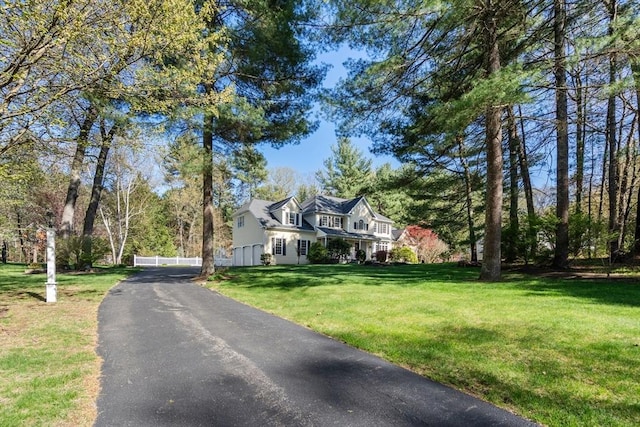20 Peakham Rd, Sudbury, MA 01776 - view of front of property with aphalt driveway, fence, and a front yard