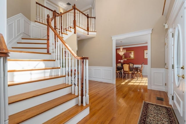 20 Peakham Rd, Sudbury, MA 01776 - staircase featuring a chandelier, visible vents, ornamental molding, and wood finished floors