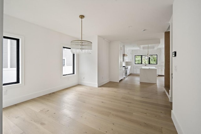 228 Auburn St Unit 228, Newton, MA 02466 - unfurnished room featuring a chandelier and light wood finished floors