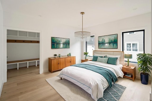 228 Auburn St Unit 228, Newton, MA 02466 - bedroom featuring light wood-type flooring and a chandelier