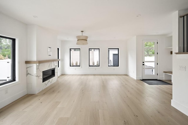 228 Auburn St Unit 228, Newton, MA 02466 - unfurnished living room featuring a fireplace and light wood-type flooring