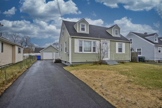 cape cod house with an outbuilding, a front yard, fence, and a garage